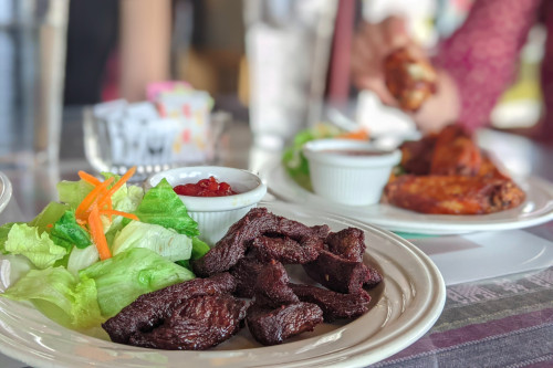 Thai beef jerky appetizer with sauce and salad